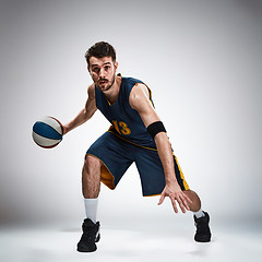 Image showing Full length portrait of a basketball player with ball 