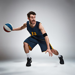 Image showing Full length portrait of a basketball player with ball 