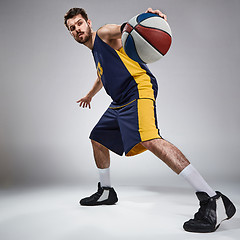 Image showing Full length portrait of a basketball player with ball 