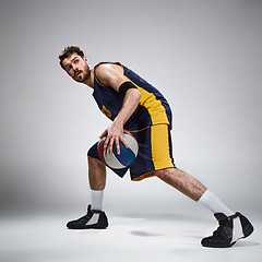 Image showing Full length portrait of a basketball player with ball 