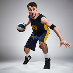 Image showing Full length portrait of a basketball player with ball 