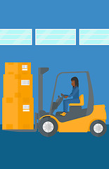 Image showing Warehouse worker moving load by forklift truck.