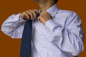 Image showing Taking off the tie