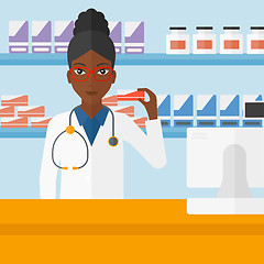 Image showing Pharmacist showing some medicine.