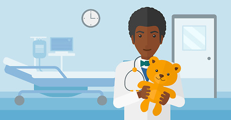 Image showing Pediatrician holding teddy bear.