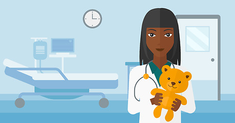 Image showing Pediatrician holding teddy bear.