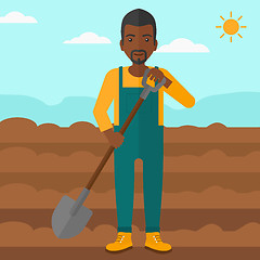 Image showing Farmer on the field with shovel.