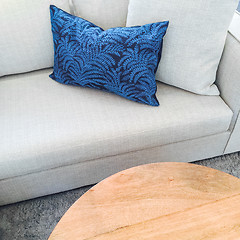 Image showing Coffee table and sofa with blue cushion