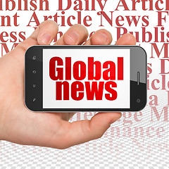 Image showing News concept: Hand Holding Smartphone with Global News on display