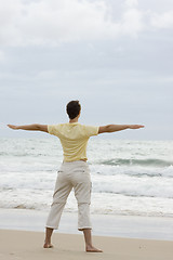 Image showing Woman doing yoga on beach