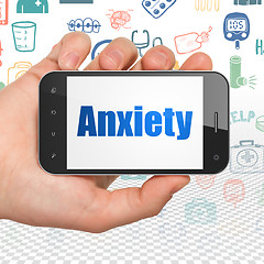 Image showing Healthcare concept: Hand Holding Smartphone with Anxiety on display