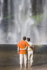 Image showing Couple contemplating a waterfall