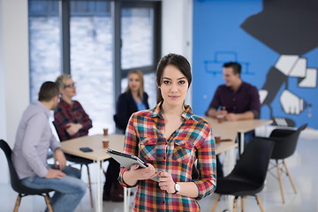 Image showing portrait of young business woman at office with team in backgrou