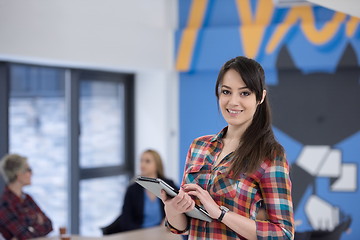 Image showing portrait of young business woman at office with team in backgrou