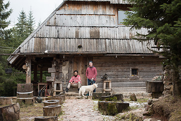 Image showing frineds together in front of old wooden house