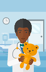 Image showing Pediatrician holding teddy bear.