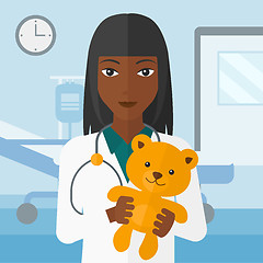 Image showing Pediatrician holding teddy bear.