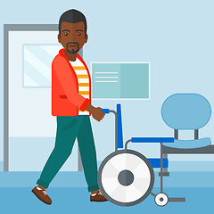 Image showing Man pushing wheelchair.