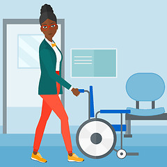 Image showing Woman pushing wheelchair.