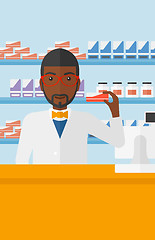 Image showing Pharmacist showing some medicine.