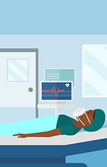 Image showing Patient lying in hospital bed with heart monitor.