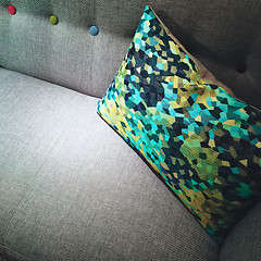 Image showing Decorative green and yellow cushion on a sofa