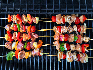 Image showing Barbecue grill with meat and vegetable skewers