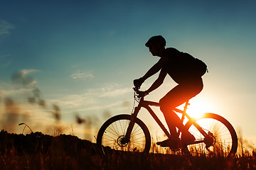 Image showing Man Cyclist with bike on sunset