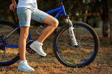 Image showing teenage girl with bike in the city park