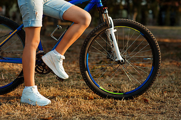 Image showing teenage girl with bike in the city park