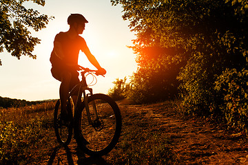 Image showing Man Cyclist with bike on sunset