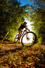 Image showing Man Cyclist with bike on sunset