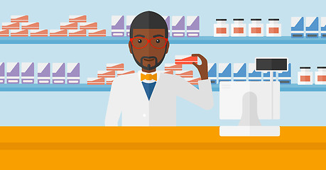 Image showing Pharmacist showing some medicine.