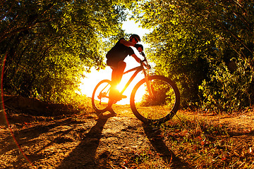 Image showing Man Cyclist with bike on sunset