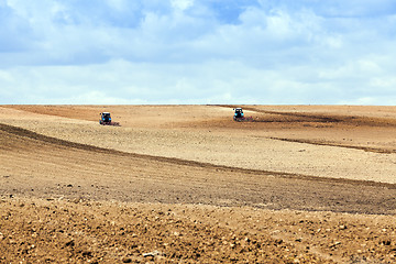 Image showing tractor plowing field  