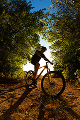 Image showing Man Cyclist with bike on sunset