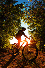 Image showing Man Cyclist with bike on sunset