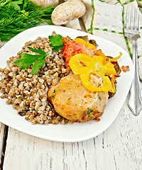 Image showing Cutlets of turkey with buckwheat and vegetables in plate on boar
