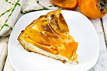 Image showing Pie with curd and persimmons in plate on light board