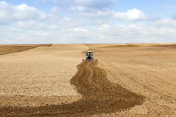 Image showing tractor plowing field 