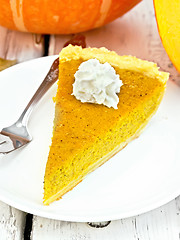 Image showing Pie pumpkin with whipped cream in plate on board