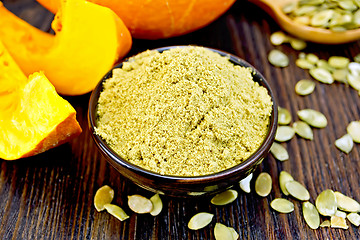 Image showing Flour pumpkin in bowl with seeds on board