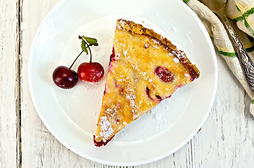 Image showing Pie cherry with sour cream in plate on board top