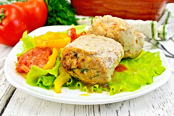 Image showing Cutlets of turkey with vegetables in plate on board