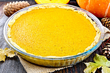 Image showing Pie pumpkin in glass pan on dark board