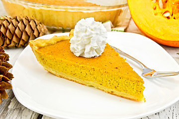 Image showing Pie pumpkin in plate with cream on light board