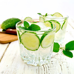 Image showing Lemonade with cucumber and mint in two glassful on board