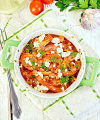 Image showing Shrimp and tomatoes with feta in pan on napkin top