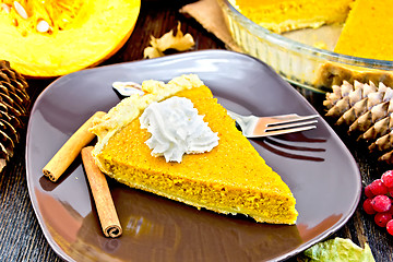 Image showing Pie pumpkin in plate with whipped cream on board