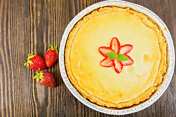 Image showing Pie strawberry with sour cream and berries on board top